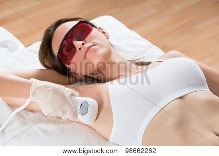 Beautician Removing Hair Of Woman With Epilator