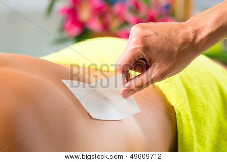 Man in Spa getting back waxed or sugared for hair removal