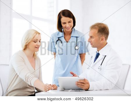 healthcare, medical and technology - doctor showing something to patient on tablet pc