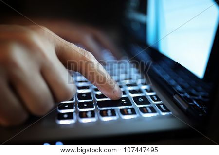 Late night internet addiction or working late man using laptop computer in the dark