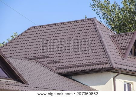 The Roof Of Corrugated Sheet. Brown Corrugated Metal Profile Roof.