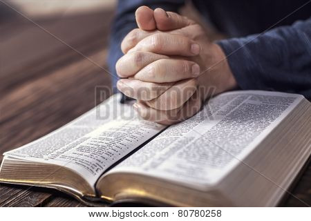 Man reading from the holy bible, close up