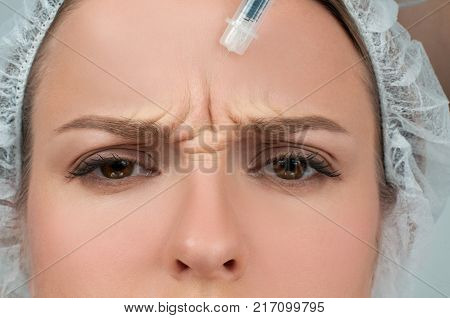 Woman is getting injection. Anti-aging treatment and face lift. Cosmetic Treatment. Facial skin lifting injection to woman's face. Plastic Surgery