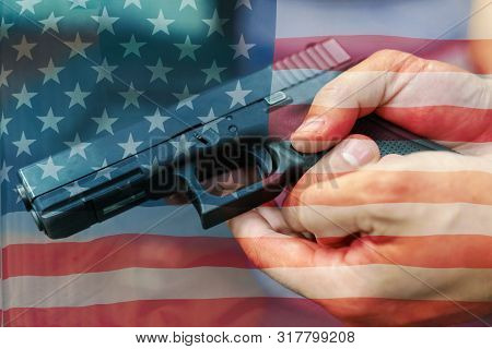 United States Gun Laws - Guns And Weapons. A Hand Of Man Practicing Firing Using A Glock Gun Model A