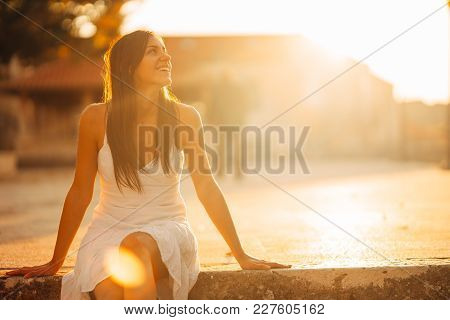 Carefree woman enjoying in nature,beautiful red sunset sunshine.Finding inner peace.Spiritual healin