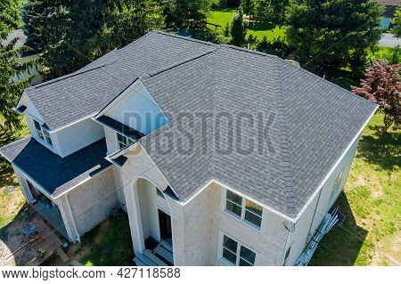 Aerial View Of Asphalt Shingles Construction Site Roofing The House With New Window