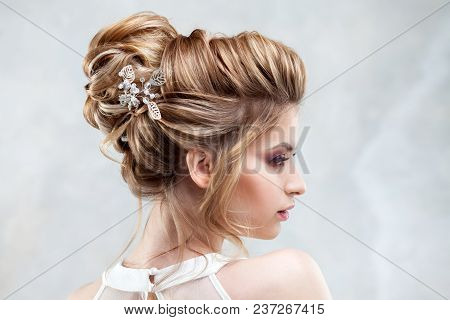 Young Beautiful Bride With An Elegant High Hairdo. Wedding Hairstyle With The Accessory In Her Hair.