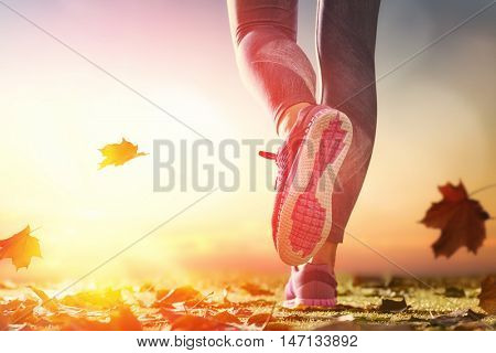 athlete's foots close-up on autumn walk in nature outdoors. healthy lifestyle and sport concepts.