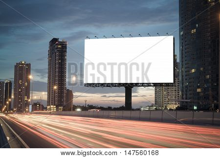 blank billboard on the highway blank billboard during the twilight light blank billboard in city background. With clipping path on screen.- can be used for display your products or promotional