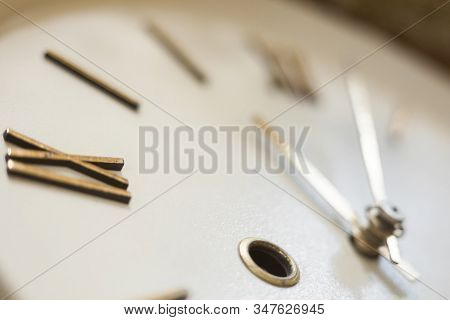 Clock Face Of The Old Wall Clock. Roman Numerals. Hour And Minute Hands. Time Concept. Close-up.