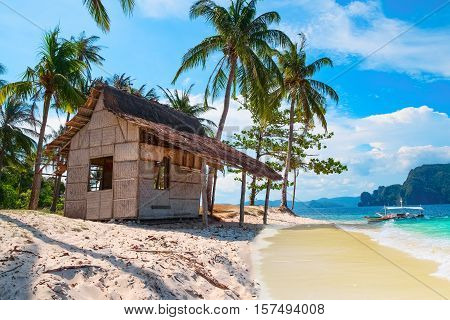 Scenic tropical landscape El Nido Palawan Philippines Southeast Asia. Beautiful tropical island with hut sandy beach palms. Sea bay scenery. Popular landmark tourist destination of Philippines