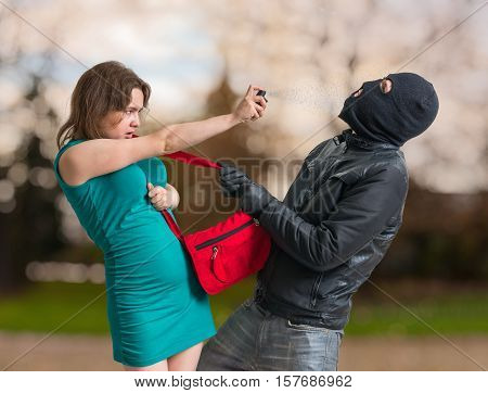 Self Defense Concept. Young Woman Is Spraying With Pepper Spray