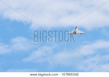 Fighter Jet flying away from camera with afterburners