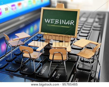 Webinar concept. Schooldesk and chalkboard on the laptop keyboard. 3d