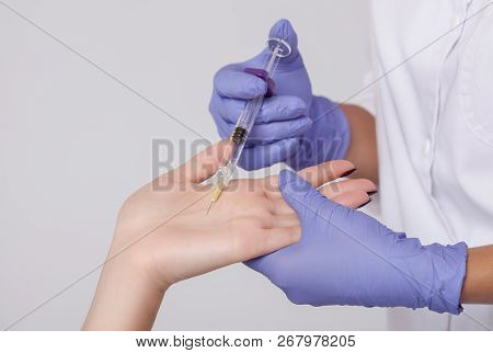 The Doctor Makes Intramuscular Injections Of Botulinum Toxinon The Palms Of A Woman Against Hyperhid