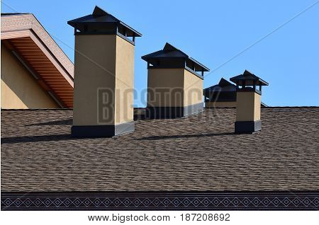 Modern Roofing And Decoration Of Chimneys. Flexible Bitumen Or Slate Shingles. The Absence Of Corros