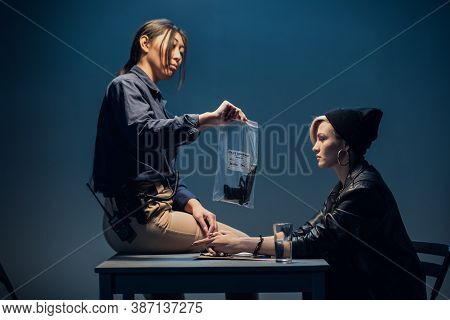 An Experienced Investigator During An Interrogation At A Police Station Shows The Criminal Girl The 