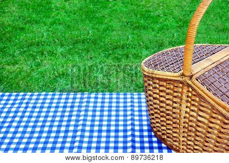 Picnic Basket On The Table With Blue White Tablecloth