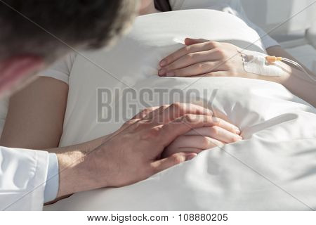 Oncologist Holding Hand Of Girl