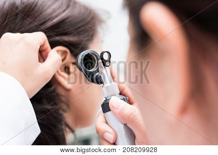 Doctor examined the patient's ear with Otoscope. Patient seem to have problems with hearing.