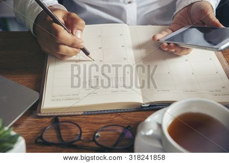 On 2020 Calendar Book,female'hand Of Planner Writing Daily Appointment.woman Mark And Noted Schedule