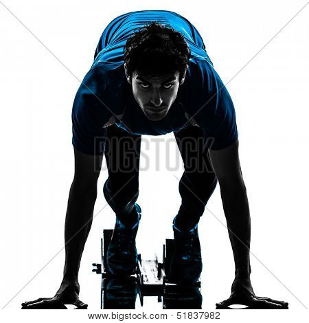 one caucasian man runner sprinter on starting blocks  in silhouette studio isolated on white background