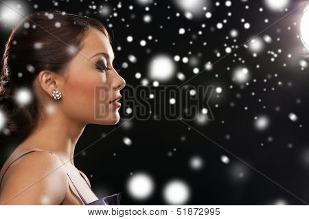 luxury, vip, nightlife, party, christmas, x-mas, new year's eve concept - beautiful woman in evening dress wearing diamond earrings