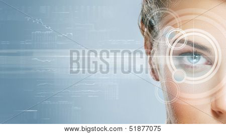 Close-up portrait of young and beautiful woman with the virtual hologram on her eyes (laser medicine and security technology concept)