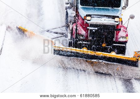 Snowplow Removing The Snow From The Highway During A Snowstorm