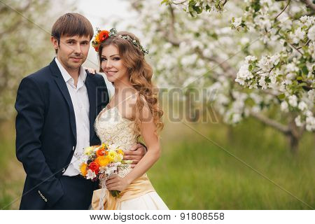 The bride and groom - photo in a flowery Park in the spring.