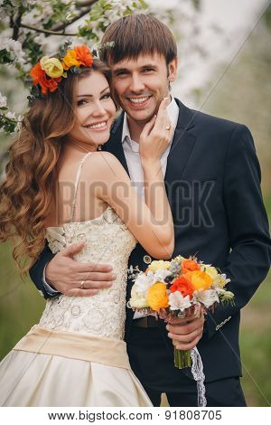 The bride and groom - photo in a flowery Park in the spring.