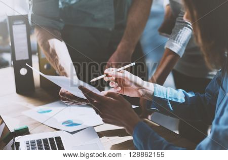 Photo team work process, holding contract hand, signs documents. Account managers young crew works with startup project.New idea presentation, analyze marketing reports.Blurred, film effect, horizontal.