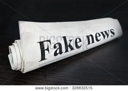 Fake News Newspaper On Desk In The Office. Daily News Newspaper Headline Reading Fake News Concept F