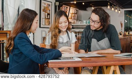 Cheerful Asian Small Business Owners Couple Meeting With Consultant Talking About Business Plan And 