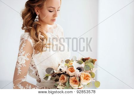 Young attractive bride with a wedding bouquet