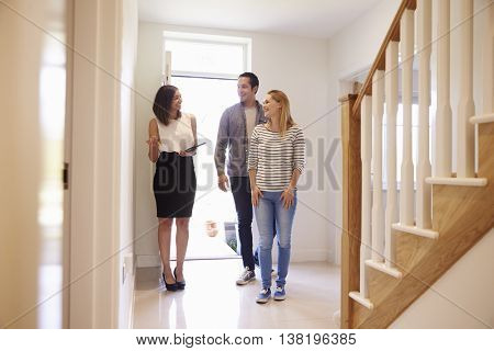 Realtor Showing Young Couple Around Property For Sale