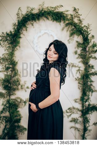 Beauty Pregnant Woman in black dress. Beautiful Pregnant Woman Expecting Baby.