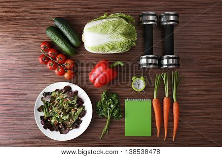 Workout and fitness dieting concept. Fitness equipment and healthy food