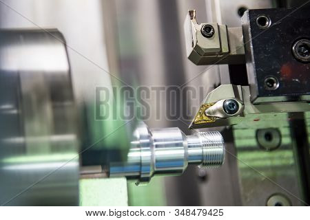 The Cnc Lathe Machine In Metal Working Process Cutting Thread The Metal Shaft Parts With In The Ligh