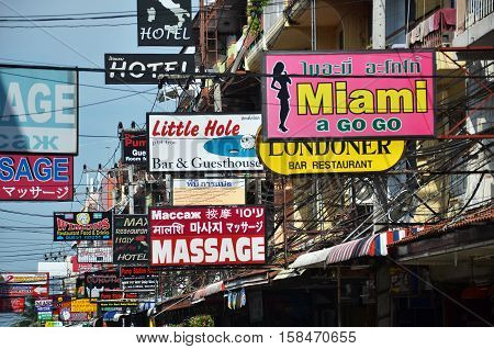 PATTAYA THAILAND - 22 NOV 2016: Massage and other multicolored signs on the street of Beach Road. The average price for one hour of oil massage is 300 baht around 10 dollars.