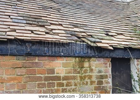 Damaged Clay Roof Tiles On A Pitched Roof On A Derelict House In England, Uk