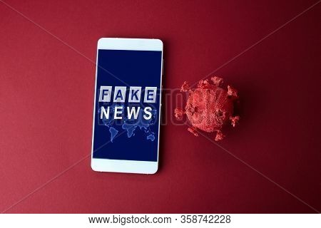 Fake News Coronavirus On Red Background . Fake News Mobile Concept.