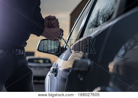 Auto Thief In Black Balaclava Trying To Break Into Car