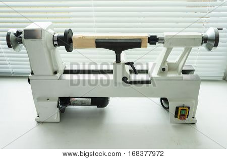 Woodworking Machine, Mini Woodworking Lathe Close Up Detail, Wood Shavings Tools, Woodworking Machinery, Small Woodwork Lathe in a Joinery Workshop, Woodwork on the Machine, Spindle Turning