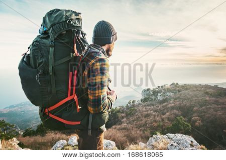 Man Traveler with big backpack hiking mountains expedition Travel Lifestyle success concept adventure active vacations outdoor mountaineering sport