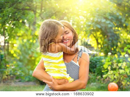 Beautiful Mother And her little daughter outdoors. Nature. Beauty Mum and her Child playing in Park together. Outdoor Portrait of happy family. Happy Mother's Day Joy. Mom and Baby.