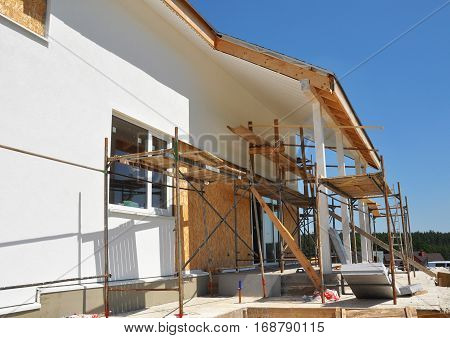 Home Remodeling and Renovation. Construction or Repair of the Rural House with Skylights Eaves Windows Fixing Facade Insulation Plastering and Painting House Facade Wall. Install Plastic Siding Soffits and Eaves Exterior.