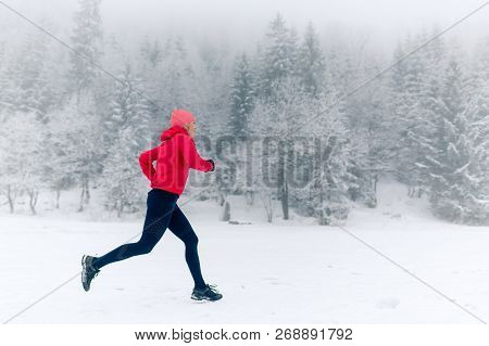 Happy Girl Running On Snow In Winter Mountains. Sport, Fitness Inspiration And Motivation. Young Hap