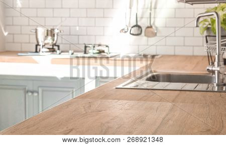 Kitchen Room And Background Concept - Blurred Brown Wooden Top Of Kitchen Counter With Beautiful Mod