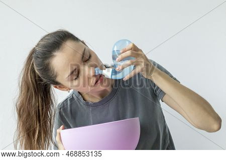 Nasal Irrigation. A Young Girl Uses The Neti Pot To Treat Her Runny Nose And Colds. Nasal Lavage, Ir